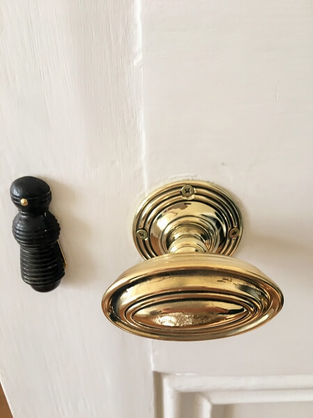 A brass doorknob on a period door in Terenure after being restored by Impressions painting and decorating