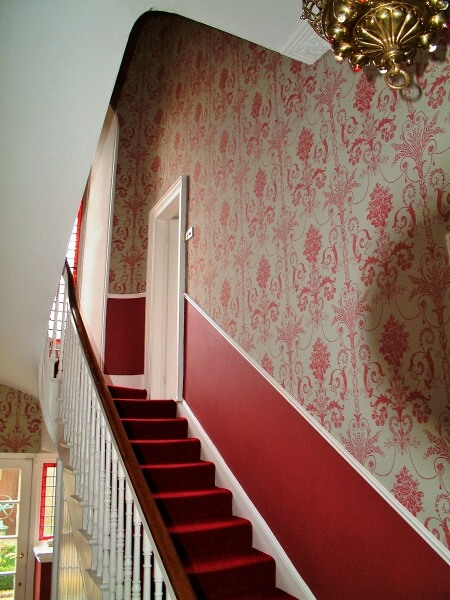 A wallpapered hall and staircase in Dublin by Impressions Wallpaper Installation Period Houses