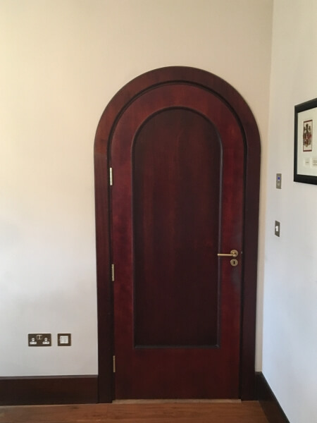 A wooden interior door before being painted by Impressions painters and decorators in Kilmacanogue