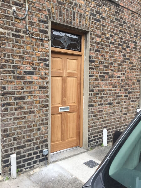 New hardwood door before being painted by Impressions painters and decorators in Dublin