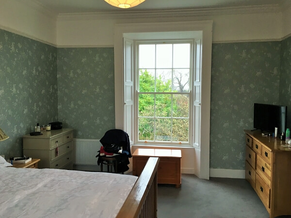 Bedroom wallpapering and painting in a period house restoration by Impressions Painting and Decorating