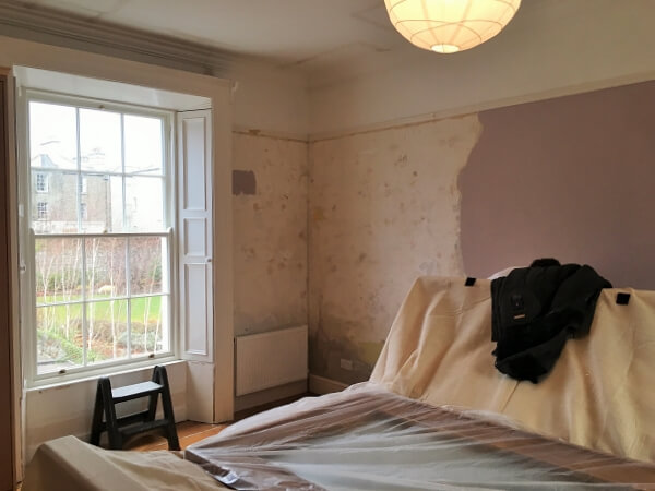 Before photo of a master bedroom in a period house that was wallpapered and painted by Impressions Painting and Decorating