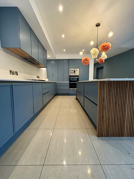 Close up of blue hand painted island on the right and blue hand painted cabinets on the left by Impressions Dublin expert house and kitchen painters